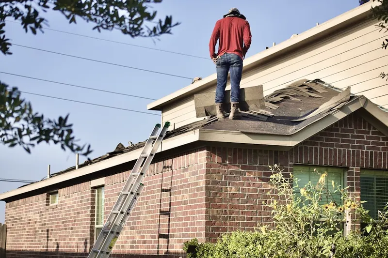 Professional roofer working on a residential roof in Nieswanders Fort